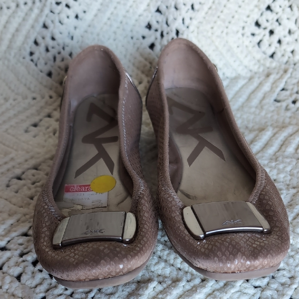 Anne Klein Sport Able ballet flats in a light brown/beige color with a buckle.